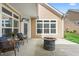 Covered patio includes a fire pit, seating, and stylish exterior lighting at 667 Ashley Woods Dr, Gibsonville, NC 27249