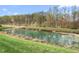 Scenic view of a peaceful pond surrounded by lush greenery and serene nature at 667 Ashley Woods Dr, Gibsonville, NC 27249