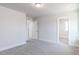 Neutral bedroom featuring a large carpeted area, multiple doors, and a walk-in closet at 68 Tee Time Ter, Benson, NC 27504