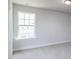 This neutral bedroom features a large window that lets in natural lighting and plush carpet at 68 Tee Time Ter, Benson, NC 27504