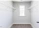 Walk-in closet with carpet, window, and shelving for storage at 68 Tee Time Ter, Benson, NC 27504