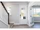Bright entryway featuring wood stairs and a stylish glass door at 68 Tee Time Ter, Benson, NC 27504