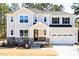 Charming two-story home with stone accents, attached garage, and landscaped front yard at 68 Tee Time Ter, Benson, NC 27504