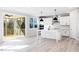 Modern kitchen with white cabinetry, island, stainless appliances, and sliding door at 68 Tee Time Ter, Benson, NC 27504