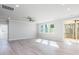Spacious living room featuring luxury vinyl flooring, windows, and sliding glass door at 68 Tee Time Ter, Benson, NC 27504