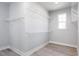 Spacious walk-in closet features wooden floor, wire shelving, and a window for natural light at 68 Tee Time Ter, Benson, NC 27504