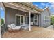 Outdoor back porch with cushioned seating and view of the landscaped backyard at 8121 Greys Landing Way, Raleigh, NC 27615