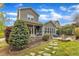 A beautiful backyard with stone walkway, patio, mature trees, and lush landscaping at 8121 Greys Landing Way, Raleigh, NC 27615