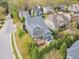 Private backyard oasis with a large deck, stone patio featuring a fire pit, and lush landscaping for ultimate relaxation at 8121 Greys Landing Way, Raleigh, NC 27615