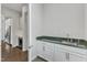 Chic bar area with sink, marble countertop, custom cabinets and beverage cooler at 8121 Greys Landing Way, Raleigh, NC 27615