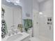 Bright bathroom featuring a glass shower, white tile, patterned floor, and ample vanity space with plants at 8121 Greys Landing Way, Raleigh, NC 27615