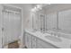 This bathroom features dual sinks, white cabinets, and a shower with a tiled backsplash at 8121 Greys Landing Way, Raleigh, NC 27615