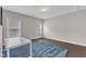 This bedroom features hardwood floors, natural light from the windows and is carpeted with a blue rug at 8121 Greys Landing Way, Raleigh, NC 27615