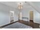 This spacious bedroom has hardwood floors with a light fixture and an ensuite bathroom at 8121 Greys Landing Way, Raleigh, NC 27615