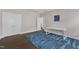 This bedroom features hardwood floors, a blue rug, and lots of light with a bonus closet and door at 8121 Greys Landing Way, Raleigh, NC 27615
