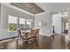Elegant dining room boasts dark hardwood floors, a wood-trimmed ceiling, and an abundance of natural light at 8121 Greys Landing Way, Raleigh, NC 27615