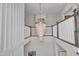 A stunning multi-tiered crystal chandelier hanging above the staircase landing at 8121 Greys Landing Way, Raleigh, NC 27615
