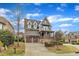Charming two-story home featuring a covered porch, stone accents, and a two-car garage at 8121 Greys Landing Way, Raleigh, NC 27615