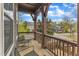 Charming covered front porch with stone flooring and wood railings offering a relaxing space to enjoy the neighborhood view at 8121 Greys Landing Way, Raleigh, NC 27615