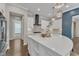 Bright, open kitchen featuring a large island, white cabinets, and pendant lighting at 8121 Greys Landing Way, Raleigh, NC 27615