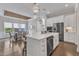 Bright, open kitchen featuring a large island with seating, modern appliances, and easy access to the dining area at 8121 Greys Landing Way, Raleigh, NC 27615