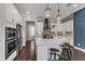Beautiful kitchen featuring white cabinets, stainless steel appliances, granite countertops, and stylish pendant lighting at 8121 Greys Landing Way, Raleigh, NC 27615