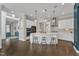 Expansive open-concept kitchen featuring a large island with stool seating, white cabinets, and modern appliances at 8121 Greys Landing Way, Raleigh, NC 27615