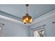 Elegant flower-shaped ceiling light fixture enhances this room with its unique design and warm glow at 8121 Greys Landing Way, Raleigh, NC 27615