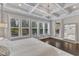 Sunlit main bedroom featuring hardwood floors and a modern chandelier at 8121 Greys Landing Way, Raleigh, NC 27615