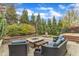 Stone patio features a fire pit, lounge seating, and a pergola-covered dining area at 8121 Greys Landing Way, Raleigh, NC 27615