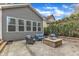 Backyard patio with a stone fire pit, comfortable seating, and privacy landscaping at 8121 Greys Landing Way, Raleigh, NC 27615