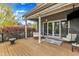 Inviting covered porch with comfortable seating, stylish rug, and outdoor lighting at 8121 Greys Landing Way, Raleigh, NC 27615