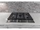 A KitchenAid gas range with stylish knobs is set into the marbled counter at 8121 Greys Landing Way, Raleigh, NC 27615