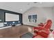 Home theater room with projector screen, comfortable seating, and hardwood flooring at 8121 Greys Landing Way, Raleigh, NC 27615