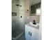 Modern bathroom with a sleek, matte black shower, patterned shower floor, and a white sink with black hardware at 825 Long Ave, Rocky Mount, NC 27801