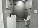 Bathroom features a sleek vanity, open toilet, and updated, tiled standing shower with a rain shower head and built-in niche at 825 Long Ave, Rocky Mount, NC 27801