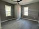 Bright bedroom featuring neutral walls, a ceiling fan, and windows, providing ample natural light at 825 Long Ave, Rocky Mount, NC 27801