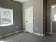 Bedroom boasting neutral-toned walls, a window that allows natural light, and a door leading to the rest of the home at 825 Long Ave, Rocky Mount, NC 27801