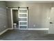 This bedroom features a sleek sliding door that reveals the bathroom with neutral walls and flooring at 825 Long Ave, Rocky Mount, NC 27801