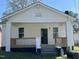 Quaint one-story home with inviting front porch featuring wooden railings at 825 Long Ave, Rocky Mount, NC 27801