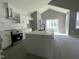 Bright kitchen featuring white cabinetry, stainless steel appliances, and a large center island with a black faucet at 825 Long Ave, Rocky Mount, NC 27801