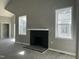 Living room with a sleek, black fireplace between two windows under tall vaulted ceilings at 825 Long Ave, Rocky Mount, NC 27801