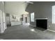 Open concept living space showcasing kitchen with modern white cabinets, fireplace and ceiling fan at 825 Long Ave, Rocky Mount, NC 27801