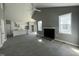 Open concept living space showcasing kitchen with modern white cabinets, fireplace and ceiling fan at 825 Long Ave, Rocky Mount, NC 27801