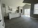 Open concept living space showcasing kitchen with modern white cabinets and stainless steel appliances at 825 Long Ave, Rocky Mount, NC 27801