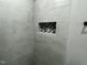 Close up of shower niche showcasing a detailed design, surrounded by neutral tile at 825 Long Ave, Rocky Mount, NC 27801