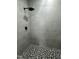 Modern shower with gray tile, black shower head and mosaic tile flooring at 825 Long Ave, Rocky Mount, NC 27801