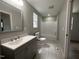 This bathroom features a large vanity, new fixtures, and a tub and shower combo at 905 Ardmore Dr, Durham, NC 27713