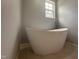 Bathroom featuring a modern free-standing tub and a window for natural light at 905 Ardmore Dr, Durham, NC 27713