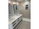 Modern bathroom featuring double sinks, sleek white cabinetry, and a luxurious walk-in shower at 905 Ardmore Dr, Durham, NC 27713